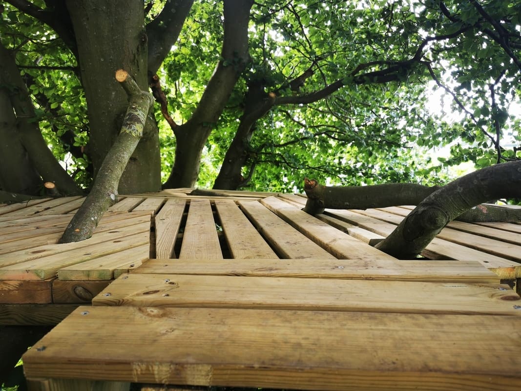 Practice yoga and meditation on the platform at Yogi Living Guesthouse retreat center in Sweden, offering peace and inspiration in a natural setting