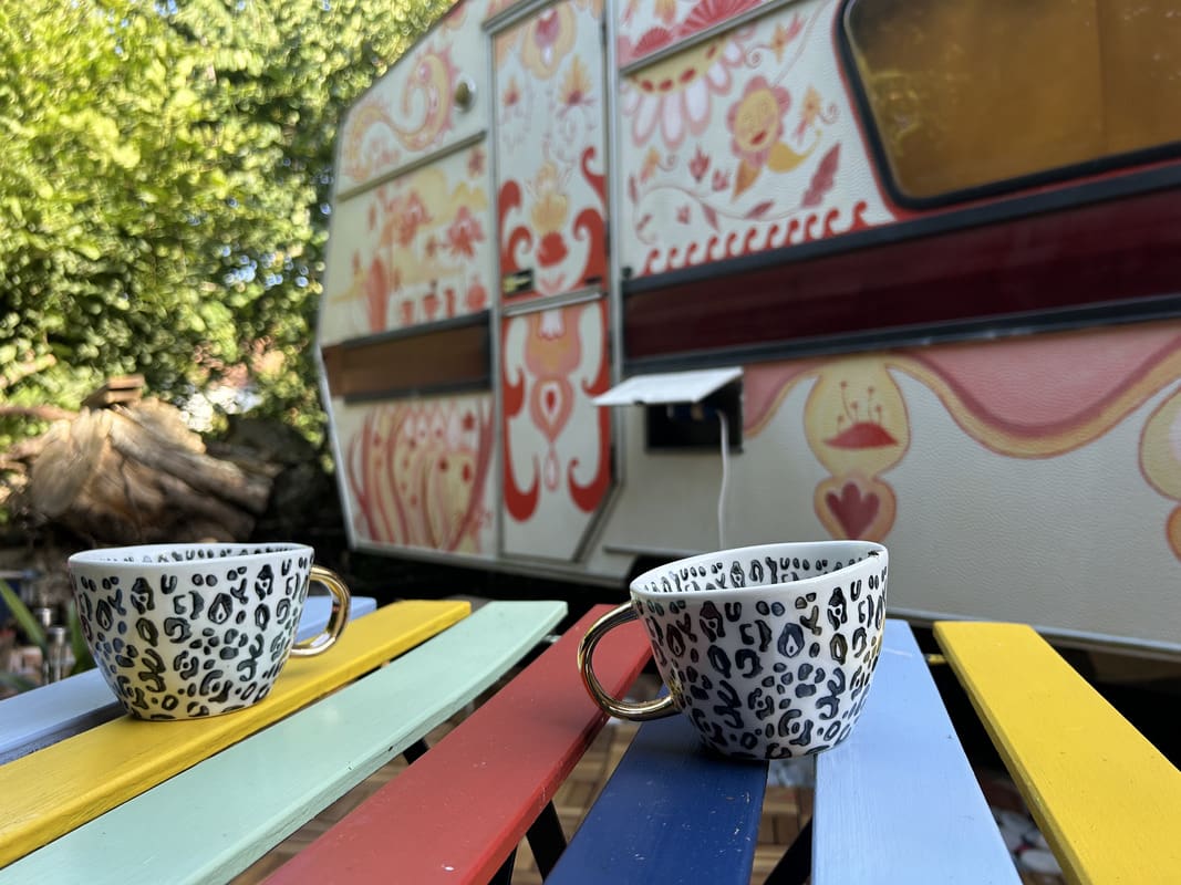 Artistic terrace table at Yogi Living Boho Caravan in Skåne, Sweden, a calm space for retreat guests